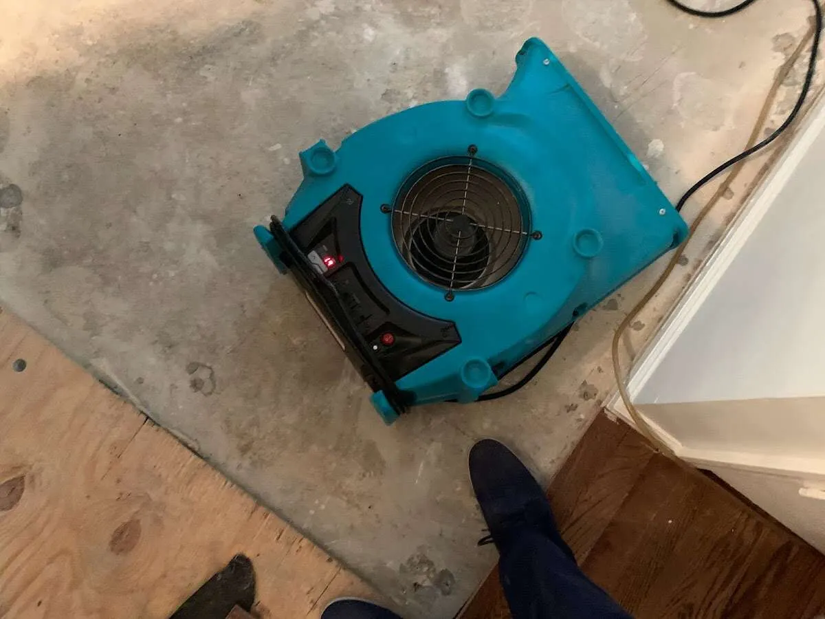 Air mover drying subfloor during Commercial Water Damage Restoration in Johnson City